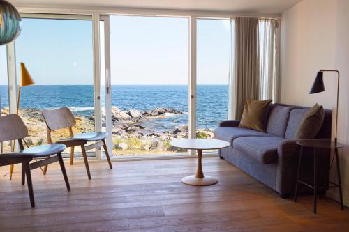 a living room with a couch and a view of the ocean at Nordlandet in Allinge