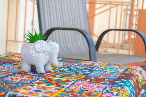 a toy elephant on a table with a plant at Gallery Suites ''Athina'' in Missolonghi
