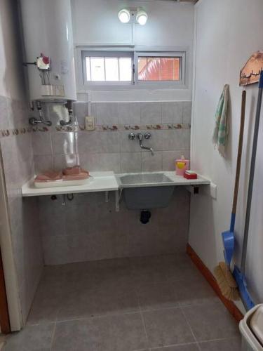 a bathroom with a sink and a bath tub at Departamento impecable. con cochera in Luján