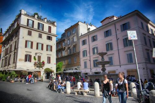 a group of people sitting on a bench in a city at Domus Real Cardello in Rome