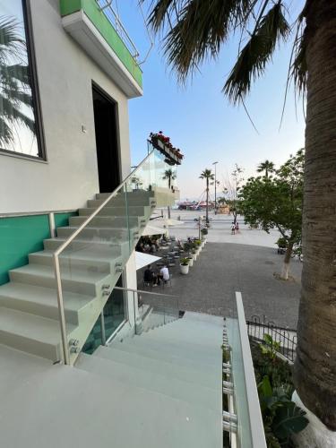 a stairway outside of a building with palm trees at Dot Tradition in Vlorë