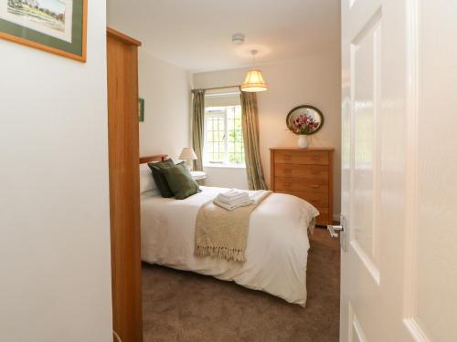 a bedroom with a bed and a window at The Coach House in Ridingmill
