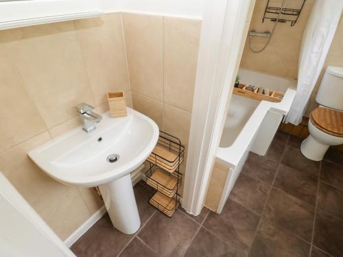 a bathroom with a sink and a toilet at The Coach House in Ridingmill