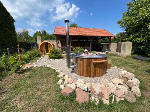 a fire pit in a yard with a bunch of rocks at Apart Pension Zelený grunt in Dřínov