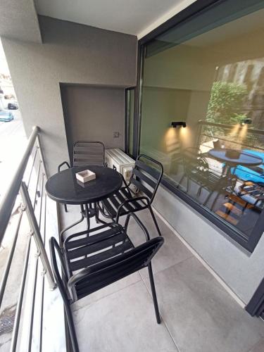 a balcony with a table and chairs on a balcony at City Center Loft With Private Parking in Kavala