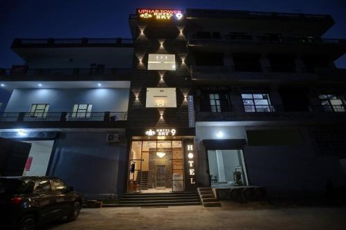a building with a front door at night at OYO Townhouse 1003 Hotel Sky 9 in Ludhiana