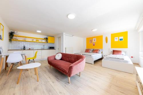 a living room with a couch and a table at Balaton Wave Apartments in Balatonalmádi