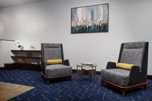 a waiting room with two chairs and a table at Courtyard Keene Downtown in Keene