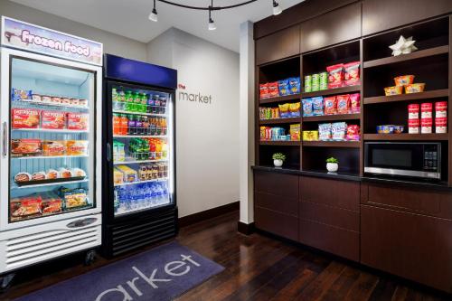 a large refrigerator in a store with food inside at Courtyard Keene Downtown in Keene