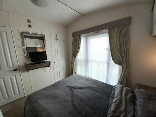 Ένα ή περισσότερα κρεβάτια σε δωμάτιο στο Luxury 8 and 6 berth caravans