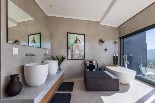 a bathroom with two sinks and a large window at The One in Knysna