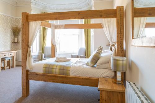 a bedroom with a wooden bunk bed in a room at 18 Craigmillar Park in Edinburgh
