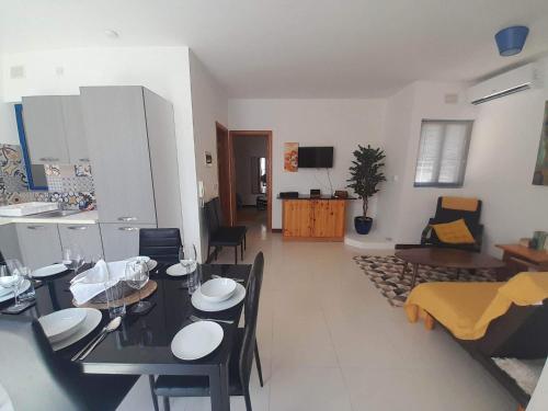 a living room with a table and a dining room at East Breeze Penthouse in Mġarr
