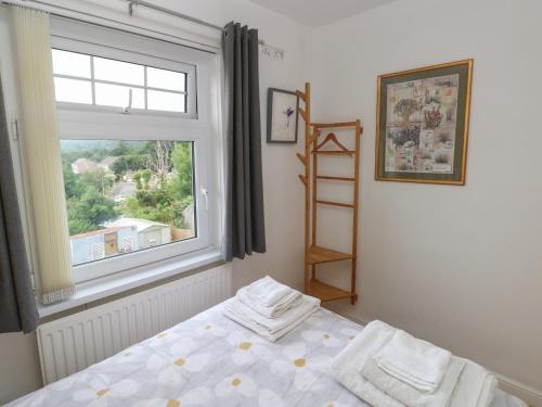 a bedroom with a bed and a window at 3 Aelybryn in Llanelli
