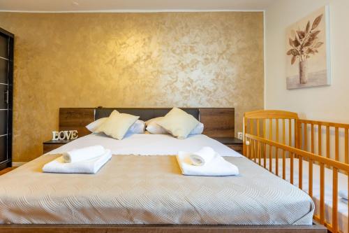 a bedroom with a bed with two towels on it at Apolon 2BDR apartment with balcony in Zadar