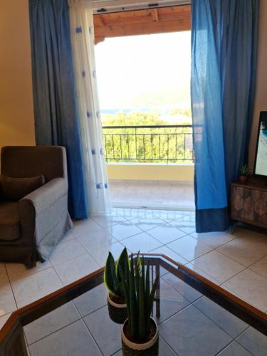 a living room with a couch and a window at K for Karavomilos in Karavomylos