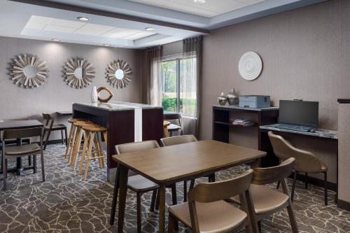 a waiting room with a table and chairs at SpringHill Suites Manchester-Boston Regional Airport in Manchester