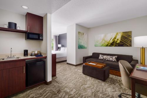 a hotel room with a kitchen and a living room at SpringHill Suites Manchester-Boston Regional Airport in Manchester