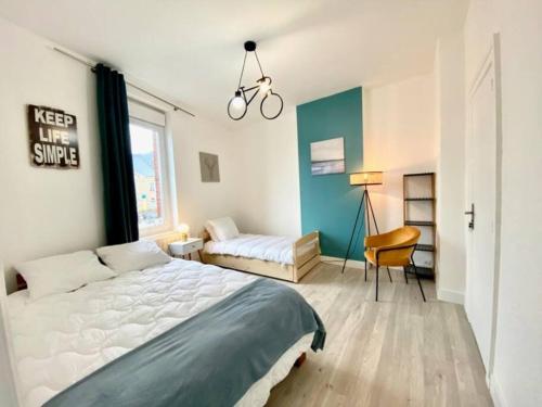 a bedroom with a bed and a bike hanging from the ceiling at Etretat au Coeur in Étretat