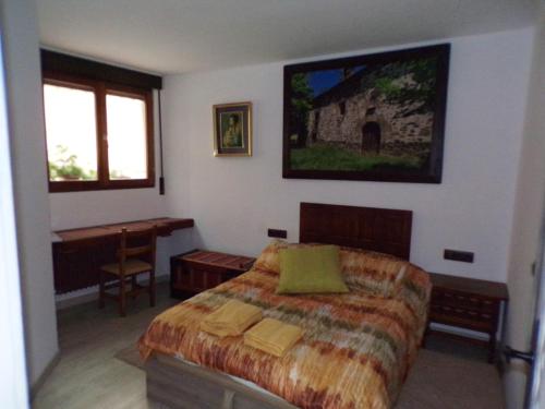 a bedroom with a bed and a table and a window at Apartamentos José Andrés by Clabao in Viana