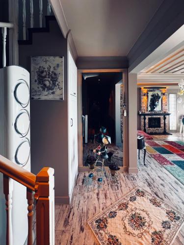 a living room with a staircase and a rug on the floor at Pearl of Black Sea in Rize
