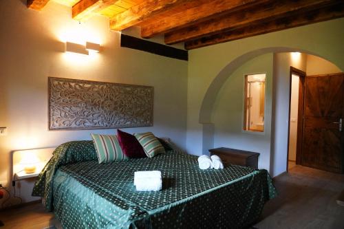 a bedroom with a bed with two towels on it at AGRITURISMO MODOLO Belluno Dolomiti in Belluno