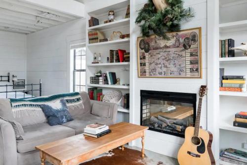 a living room with a couch and a fireplace at Hip, Cozy Cottage with a Fire Pit in Cleveland Park in Nashville