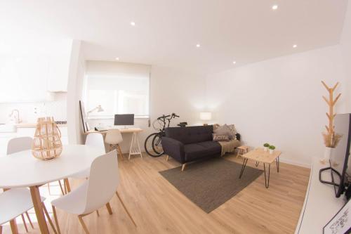 a living room with a couch and a table at Apartamento Praia Buarcos in Figueira da Foz