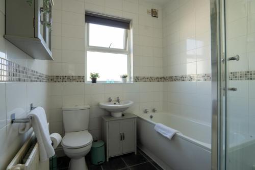 a bathroom with a toilet and a sink and a shower at Air Host and Stay - Dacy House, sleeps 7, free parking minutes from city centre in Liverpool