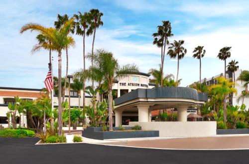 a hotel with palm trees in front of it at Atrium Hotel Orange County in Irvine