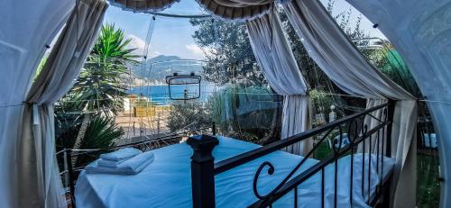 a balcony with a bed in a room with a window at Counting Stars in Recco