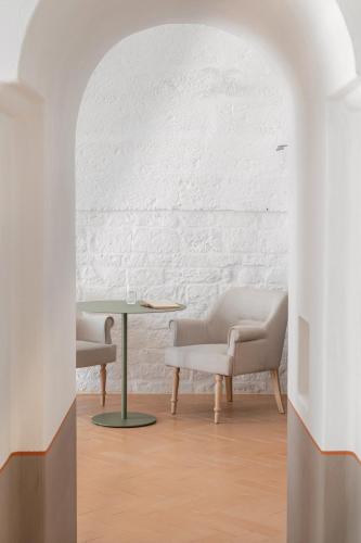 a living room with two chairs and a table at Masseria Auraterrae in Polignano a Mare
