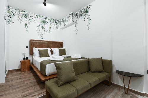 a bedroom with a bed and a couch at Sabbia Mini Pool Suites in Preveza