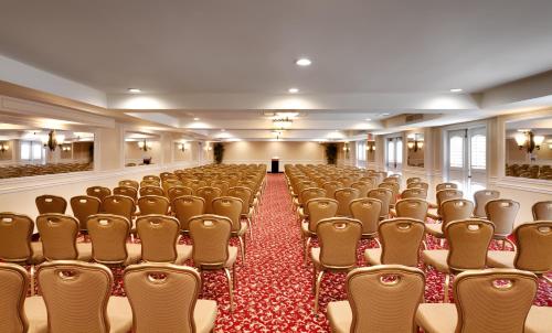 an empty conference room with chairs and a podium at Atrium Hotel Orange County in Irvine