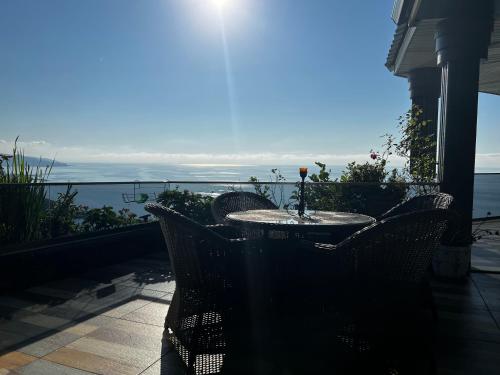 a table and chairs on a balcony with a view of the ocean at Pearl of Black Sea in Rize