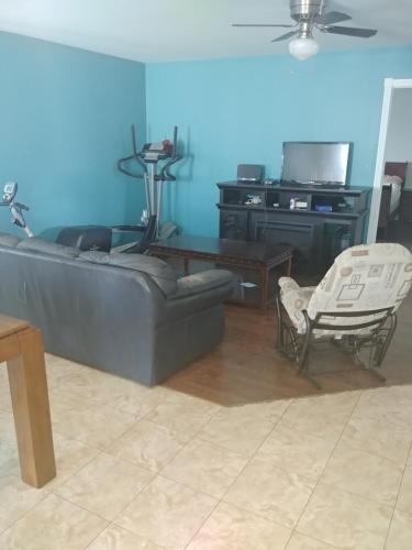 a living room with a couch and a table and chairs at Les Logements Larocque in Shippagan