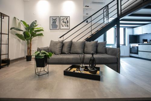 a living room with a couch and a staircase at Casa de Castro - City Apartments in Thessaloniki