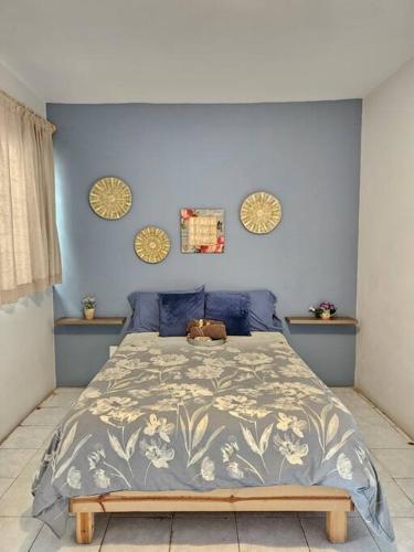 a bedroom with a large bed with a teddy bear on it at Casa Inés Terraza en Centro Histórico in Oaxaca City