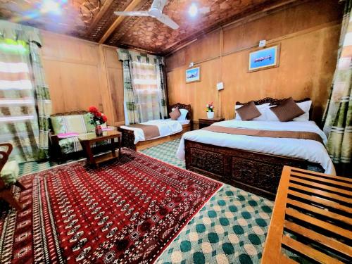 a bedroom with two beds and a rug in a room at Aziz Palace Group Of Houseboats in Srinagar