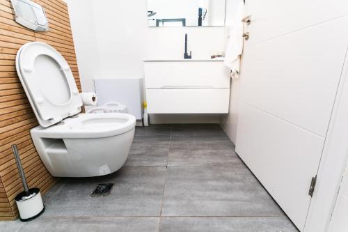 a bathroom with a toilet and a sink at LOMA in Hagoshrim