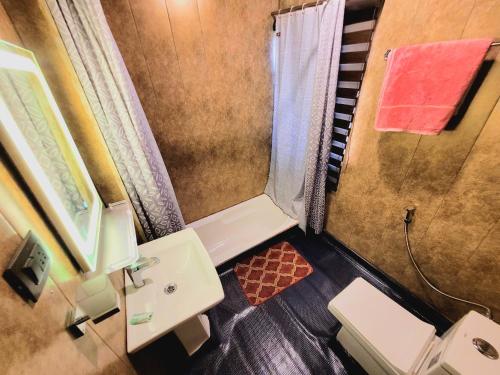 a small bathroom with a sink and a shower at Aziz Palace Group Of Houseboats in Srinagar