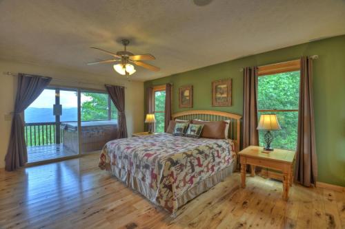 a bedroom with a bed and a wooden floor at Hummingbird Haven in Chatsworth