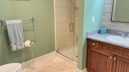 a bathroom with a shower and a toilet and a sink at Just Beachy in Union Pier