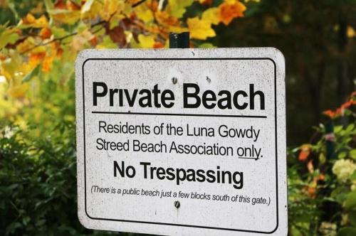 a sign that reads private beach andresidents of the luana companysteel beach at Victory Gardens in Union Pier