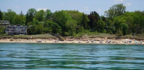 a group of people on a beach near the water at Victory Gardens in Union Pier