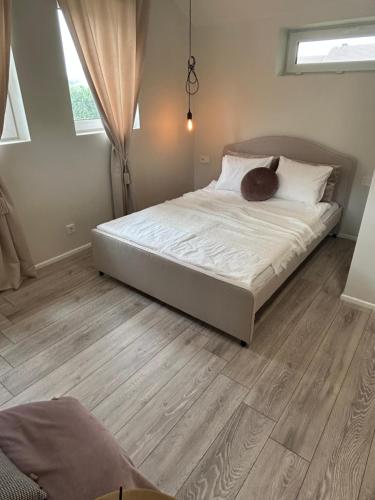a bed in a bedroom with a wooden floor at Rami Jūra2022 in Šventoji