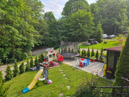 a backyard with a slide and a playground at Smile Apart in Biały Dunajec