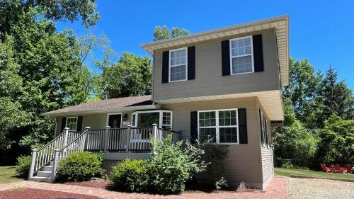 a house with a porch and a balcony at Great Escape in New Buffalo