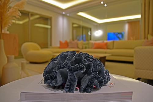 a black hat on top of a book on a table at AKS Home appart 1 - CABONEGRO in Cabo Negro
