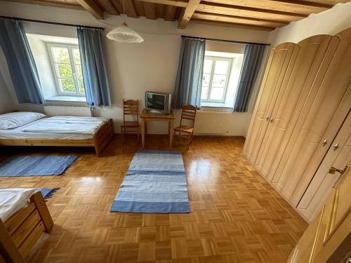 a bedroom with a bed and a table and chairs at Michlbauer - Kaufmann Aloisia in Sankt Peter ob Judenburg